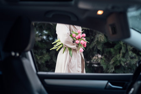 Self Care, Buy yourself flowers. Beautiful woman giving herself flowers and enjoying life outdoors sunny day.の写真素材