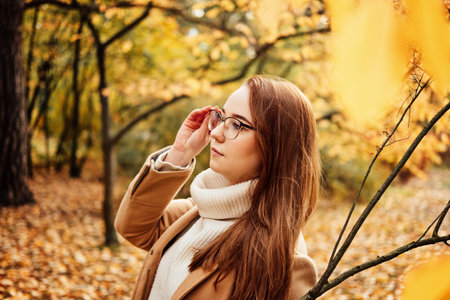 Fall Mental Wellness. Seasonal Mindful Balance. Autumn Emotional Harmony. Portrait of beautiful redhead calm serene woman fall autumn nature background.の写真素材