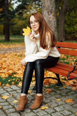 Fall Mental Wellness. Seasonal Mindful Balance. Autumn Emotional Harmony. Portrait of beautiful redhead calm serene woman fall autumn nature background.の写真素材