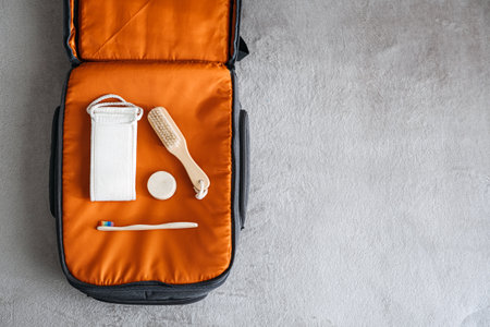 Plastic free travel, traveling sustainably. How to use less plastic on holiday. Eco Friendly Travel Products in orange suitcase.の写真素材