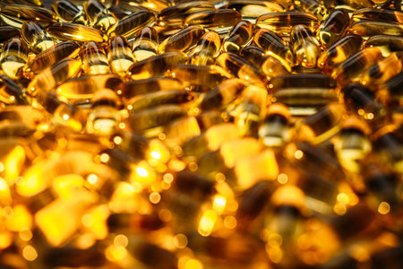 Benefits of Omega-3 for Cold Winter Months. Omega-3 fish oil Yellow Soft capsules in glass bottle on table at home. Take care of your health with fish oilの写真素材