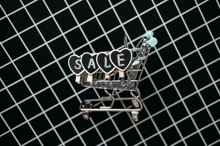 Black Friday Sale concept with shopping cart and heart shape sign SALE. Black Friday sign, Banner, poster on black checkered backgroundの写真素材