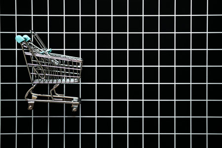 Black Friday Sale concept with shopping cart and heart shape sign SALE. Black Friday sign, Banner, poster on black checkered backgroundの写真素材