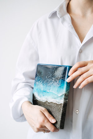 Turning Epoxy Resin Hobby Into Business. Side hustle hobby, Money-Making Crafts, DIY Crafts To Create and Make Money. Epoxy Resin artist and staff in white Epoxy Resin Art Studio.の写真素材