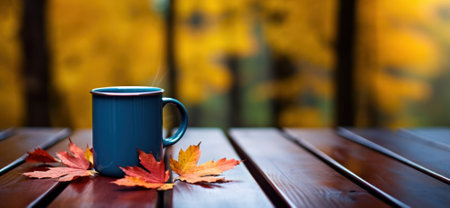 Autumn Still Life with Tea cup and fall yellow orange leaves outdoors. Fall season concept, beverage for resting time, autumn weekend mood. Homemade Drinks That Make You Feel Warm and Cozyの素材