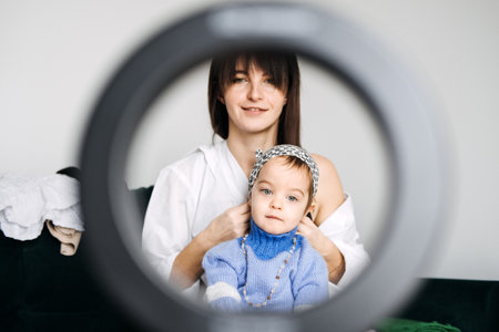 Mother and toddler creating family content at home. Content creation tips, family-friendly blogging, engaging audiences, visual storytelling, parenting momentsの写真素材