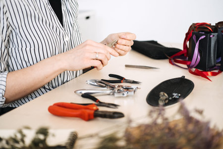 Artisan crafting workspace with jewelry-making tools. Highlighting professional craftsmanship and...