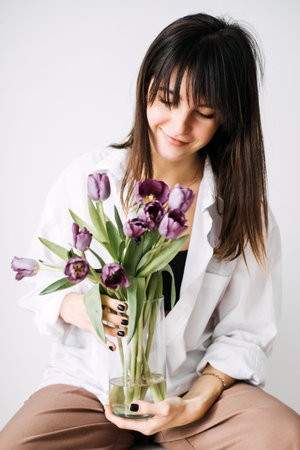 Woman holding purple tulips, embracing slow living. Mindfulness, simplicity, modern wellness, calm...
