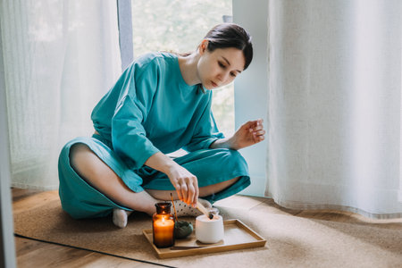 Woman setting up a wellness tray in a peaceful home corner. Creating a zen corner, indoor...