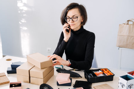 Small business owner managing orders and customer communication over the phone. Work-life balance,...