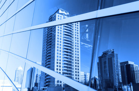 Buildings reflected in windows of modern office building