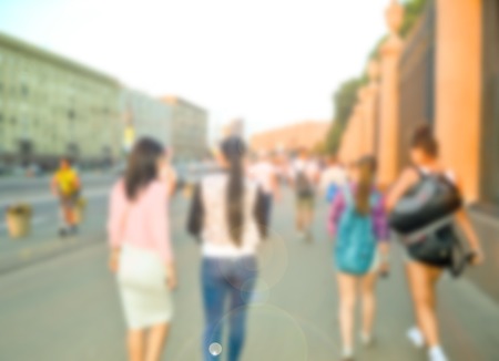 Crowd of blurred walking and talking young people in city.の写真素材