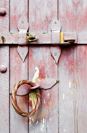 Old wooden vintage door iron handle with lock.の写真素材