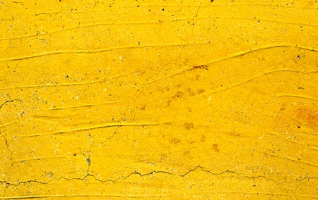 Yellow painted old dirty concrete wall texture or backgroundの写真素材