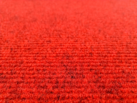 Red woolen carpet background with perspective view, selective focusの写真素材