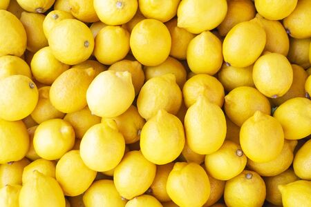 Fresh colorful lemons close-up backgroundの写真素材