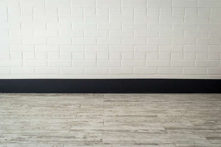 White brick wall and tile floor - interior of a corridor in the block of flatsの写真素材