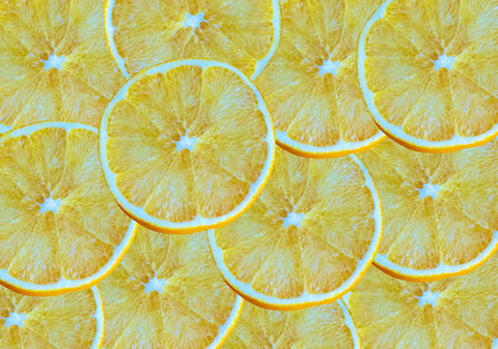 Lemon slices background. Cut yellow citrus fruit.
