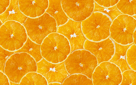 Orange slices seamless background. Cut yellow citrus fruit.の写真素材