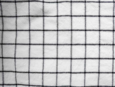 Checkered tablecloth fabric or towel. Black with white square patternの写真素材