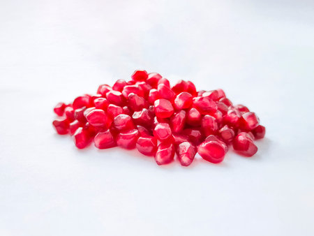 Pomegranate grains seeds on white background. Healthy fruit.の写真素材