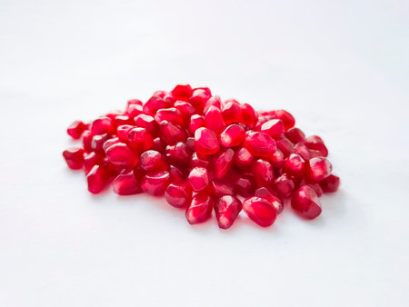 Pomegranate grains seeds on white background. Healthy fruit.の写真素材