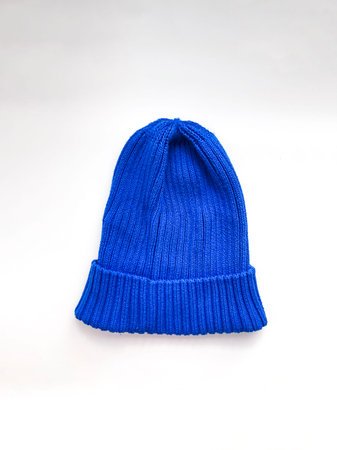 Blue knitted wool winter cap isolated on white background
