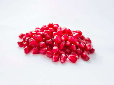 Pomegranate grains seeds on white background.の写真素材