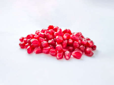 Pomegranate grains seeds on white background.の写真素材