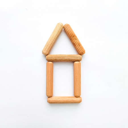 House made from wooden sticks on white background.の写真素材