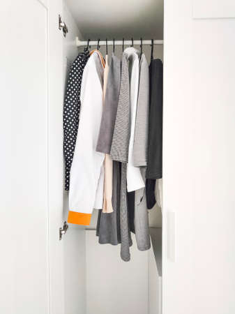 Wardrobe with basic clothes in room scandi interior. Neutral colors.の写真素材