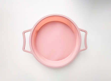New round silicone baking dish with handles isolated on white background.の写真素材