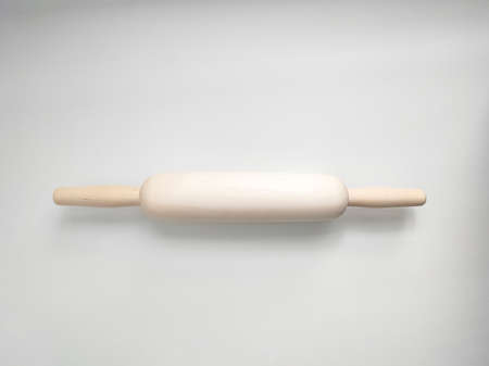 Rolling pin from natural wood on white background. kitchen utensil.の写真素材