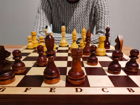 Man analyzing chess game on chess board - strategic concept.の写真素材