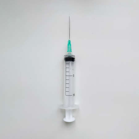Disposable medical syringe with needle on white background.の写真素材