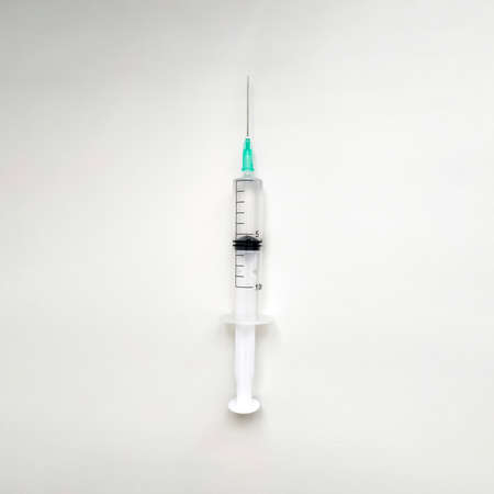 Disposable medical syringe with needle on white background.の写真素材