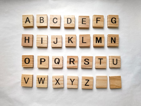 Letters of the alphabet on wooden parts on white backgroundの写真素材