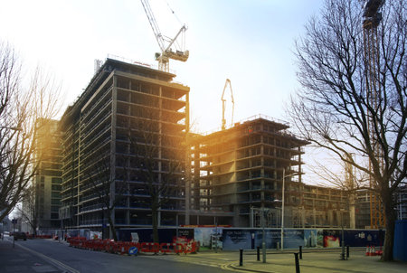 LONDON, UK - MARCH 10, 2014  Canary wharf, Construction site with cranes on sky background