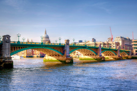 LONDON, UK - MARCH 29, 2014  South bank walk of the river Thames in twilight   View on bridge and modern architecture and ST Pauls cathedral  HDR の写真素材