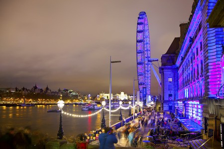 LONDON, UK - APRIL 5, 2014  London eye in the night and south bank of river Thames, famous London s walk and tourist destinationのeditorial素材
