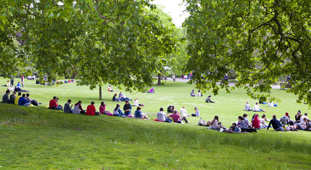 LONDON, UK - MAY 14, 2014  - Brits chilling up in Green park near the Buckingham palaceのeditorial素材