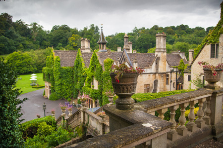 CHIPPENHAM, UK - AUGUST 9, 2014: Castle Combe, luxury house and gardens turned to be a hotel and golf clubのeditorial素材