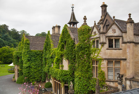 CHIPPENHAM, UK - AUGUST 9, 2014: Castle Combe, luxury house and gardens turned to be a hotel and...