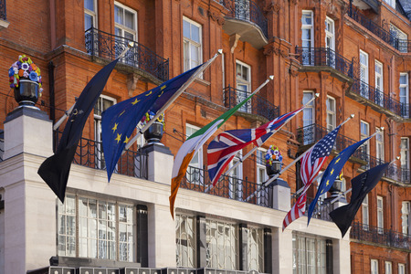 LONDON, UK - JUNE 3, 2014: International flags above the main entrance of luxury Claridges hotelのeditorial素材