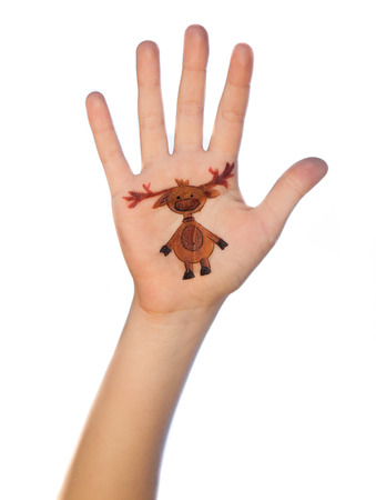 Children\'s hands raising up with painted Christmas symbol rein deerの写真素材