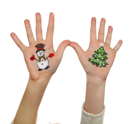 Children\'s hands with painted Christmas symbols. Santa, Christmas tree, Snowman, Reindeer, present boxの写真素材