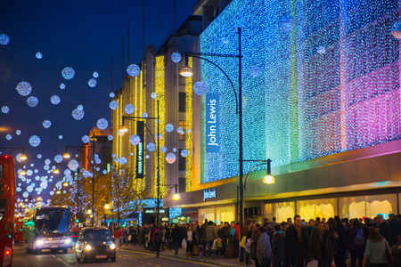 LONDON, UK - NOVEMBER 30, 2014: Christmas lights on Oxford street with crowd of people making christmas shoppingのeditorial素材