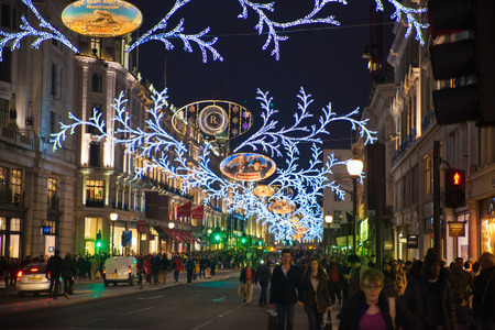 LONDON, UK - NOVEMBER 30, 2014: Christmas lights on Regent street with crowd of people making christmas shoppingのeditorial素材