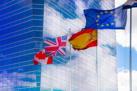 MADRID, SPAIN - July 22, 2014: International flags against of modern skyscrapersのeditorial素材