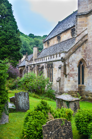 CHIPPENHAM, UK - AUGUST 9, 2014: Castle Combe, unique old English village. Old churchのeditorial素材